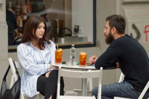 Couple talking at the table in a cafe